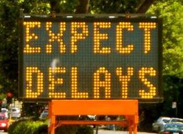 Karen McCann Expect Delays Sign