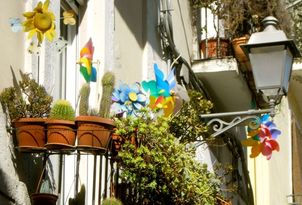 Karen McCann, Bari, Italy, old town, pinwheels on balcony