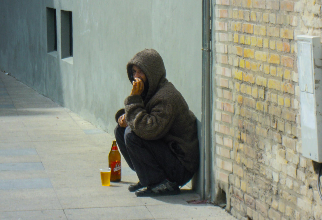 Workman taking beer and cigarette break in Seville, Spain / Disappointing Destinations: How to Love 'Em (Warts & All) / Karen McCann / EnjoyLivingAbroad.com