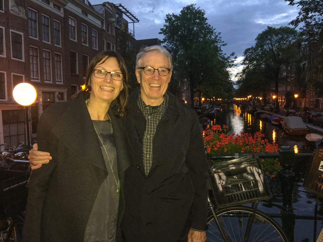 Rainy, Zany Amsterdam / Margriet and Rich on the canal at midnight / Karen McCann / EnjoyLivingAbroad.com